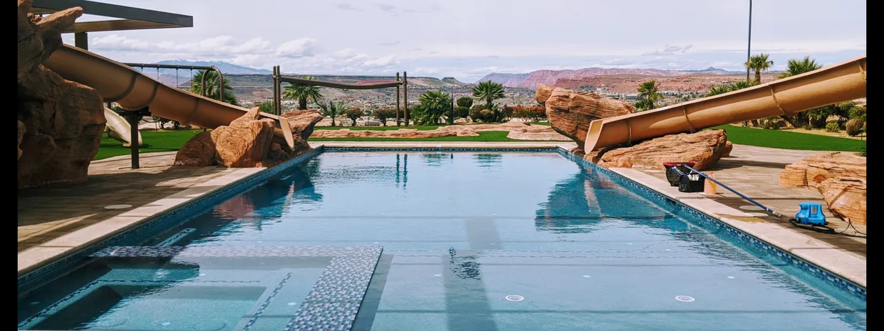 Pool with slides and cleaning tools on the deck